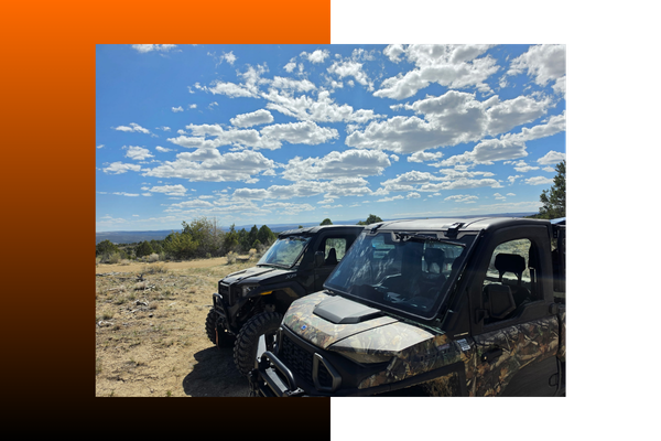 Two UTV parked next to each other outside
