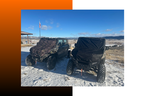 Two UTVs parked next to each other outside and covered