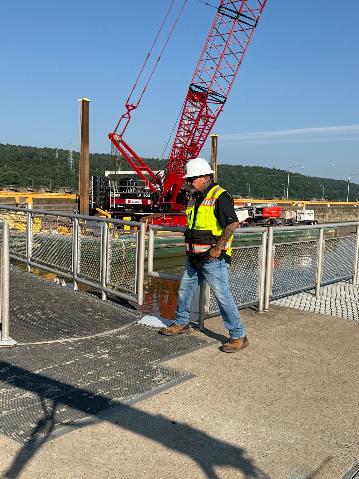 On-site leadership reviewing operations, access conditions, equipment, and changing hazards. Safety Manager Field Oversight