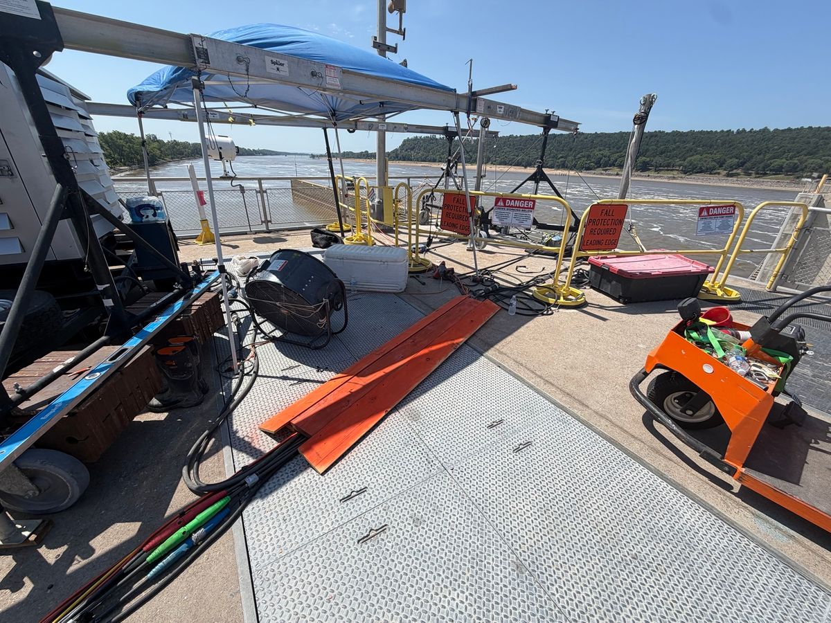 Temporary guardrails, warning signage, anchors, and equipment staged for elevated work. Leading-Edge Fall Protection Setup