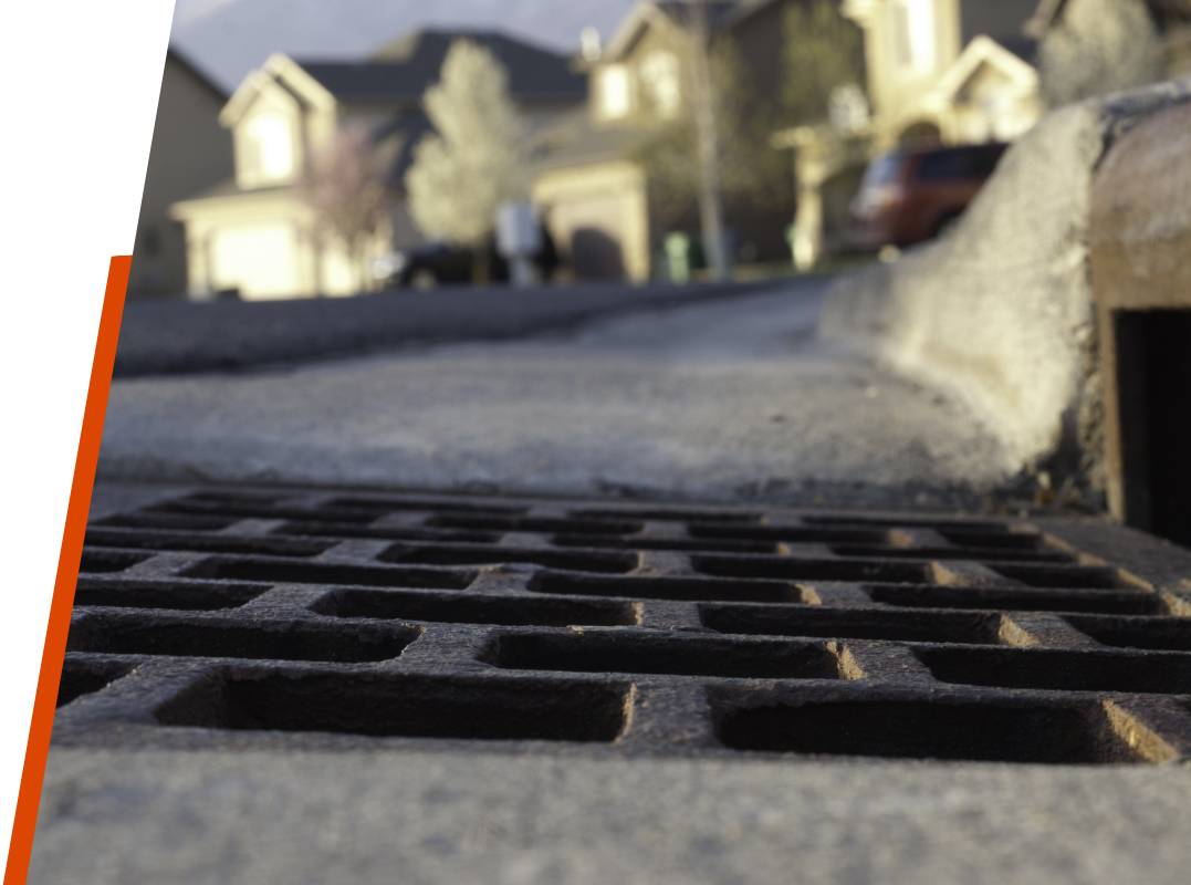 View of gutter and storm drain in neighborhood. 