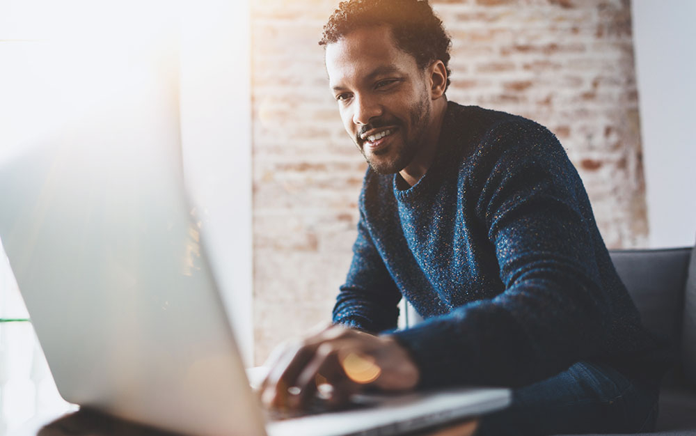 Happy man using a laptop