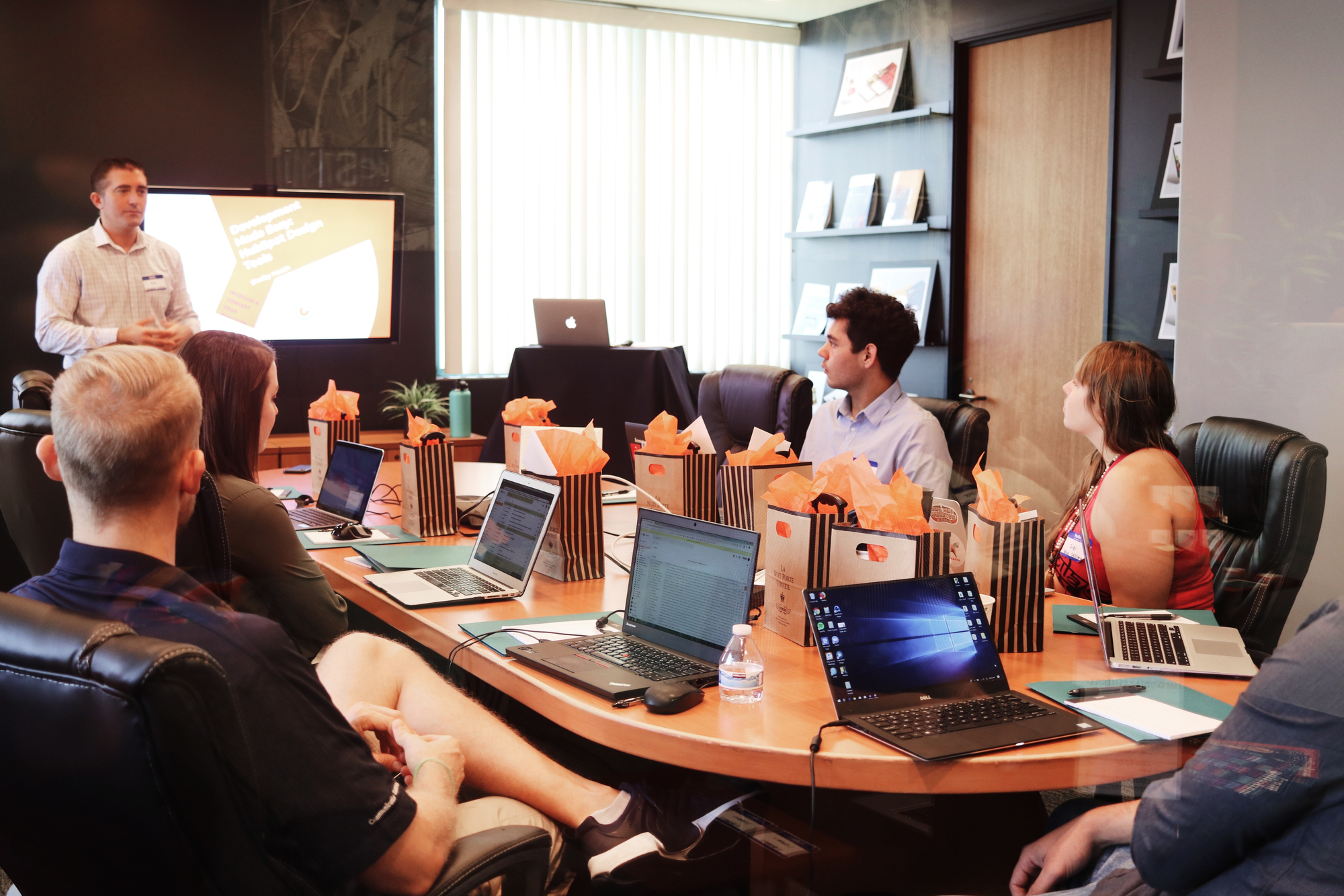 people sitting in a presentation with their laptops