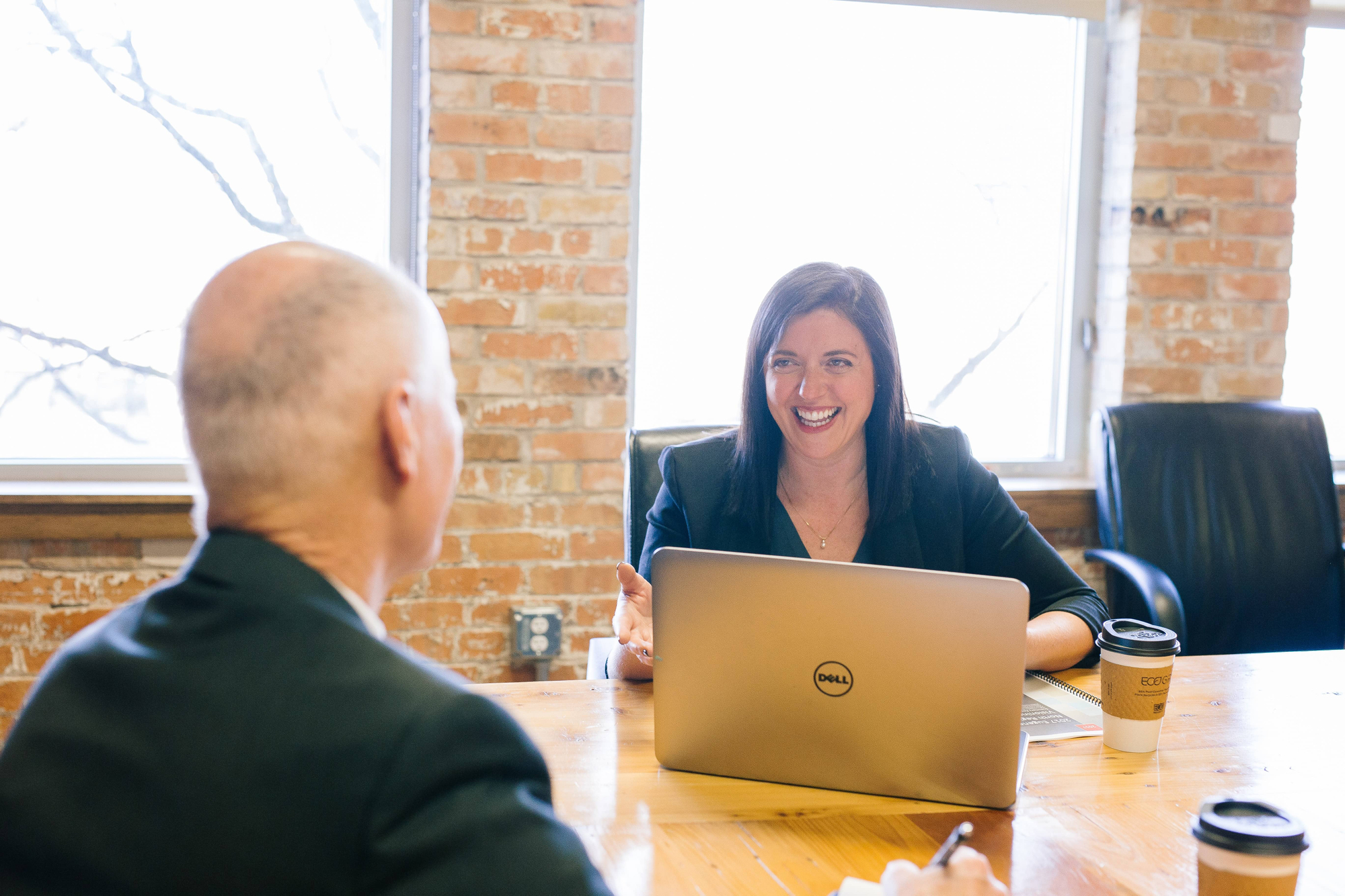 people smiling at eachother at a desk