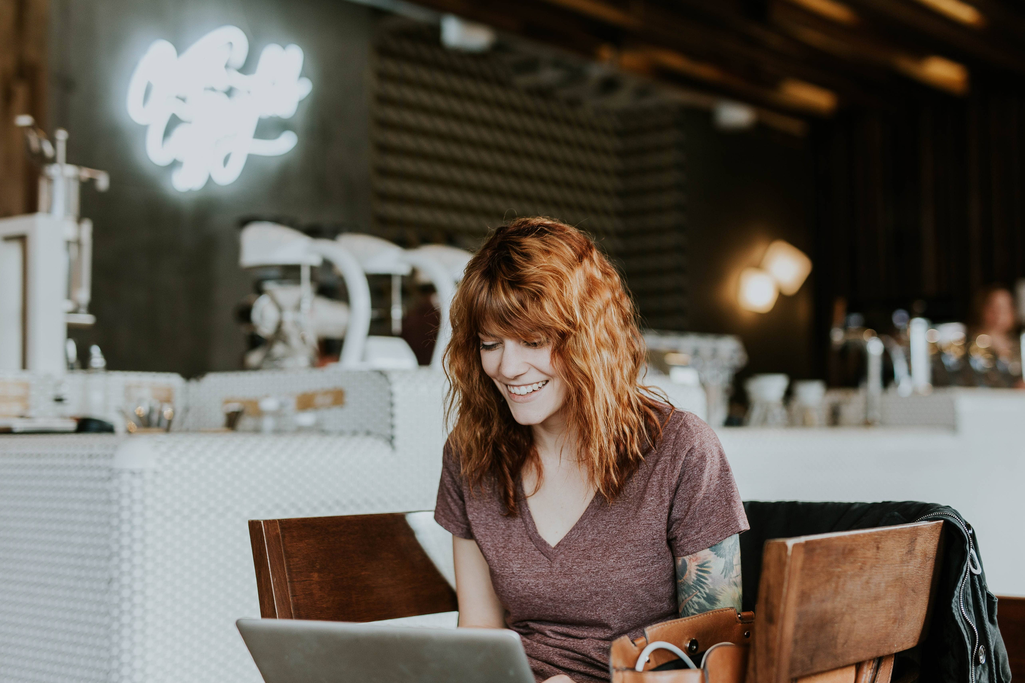 person smiling at their computer