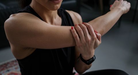 Woman stretching her elbow