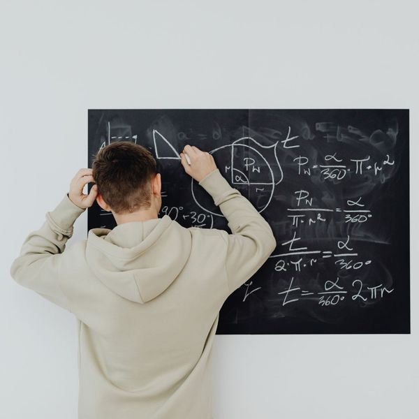 Writing math problems on a chalkboard. Writing math problems on a chalkboard.