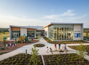 A modern civic center with large windows, featuring a playground on one side and families gardening on the other. Clear sky above. Modern Civic Center with Playground and Community Activities
