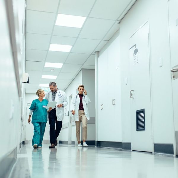 doctors speaking while walking through hospital