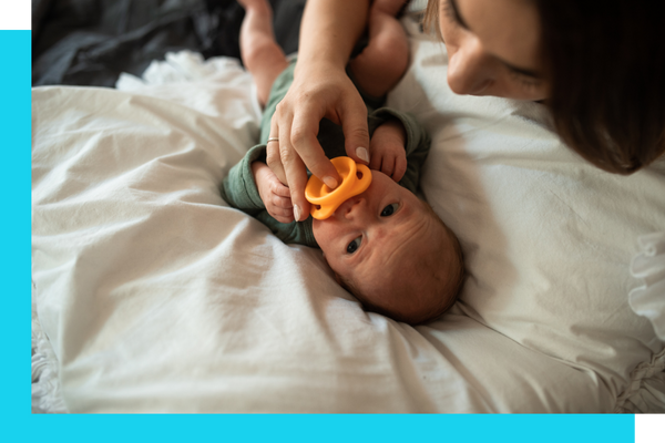 A baby sucking on a binky
