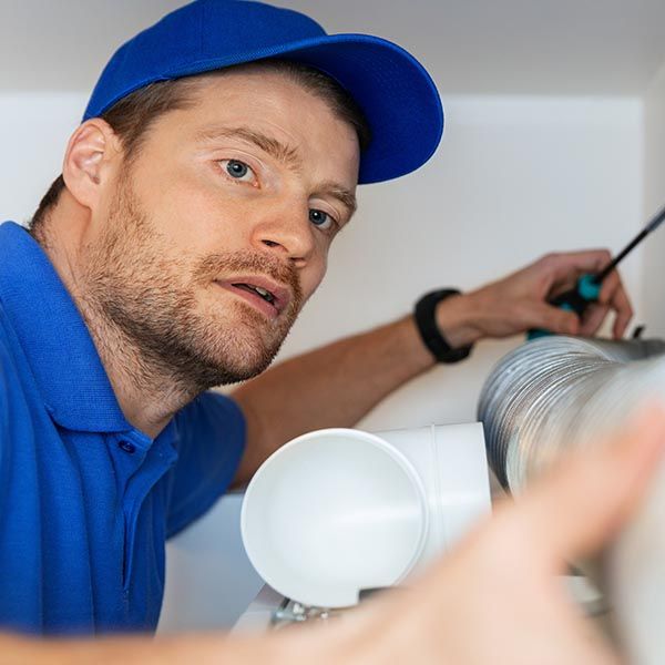 HVAC technician adjusting duct