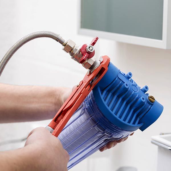 plumber installing an alkaline water filter