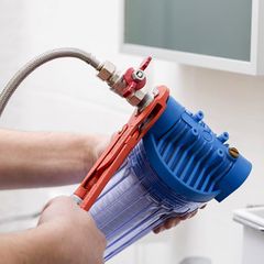 plumber installing an alkaline water filter