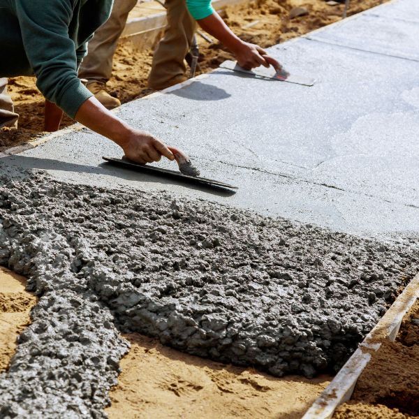 Concrete being formed into a sidewalk