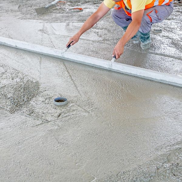 Workers smoothing out concrete