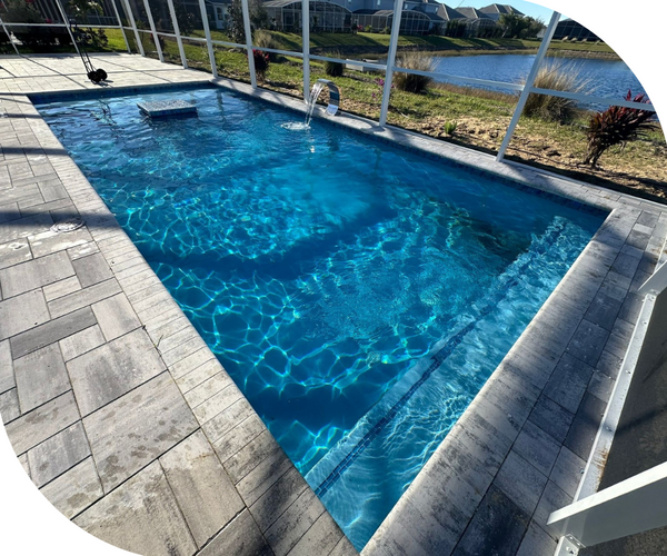 An enclosed pool next to a lake