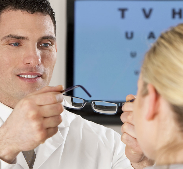 image of a woman trying on glasses
