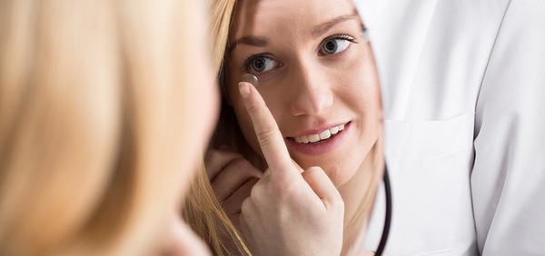 image of a woman putting in contacts