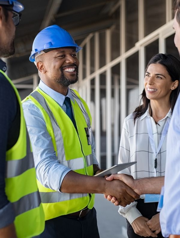 A HVAC engineer shaking hands with a commercial building owner