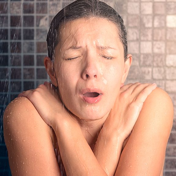 A lady shivering in cold water