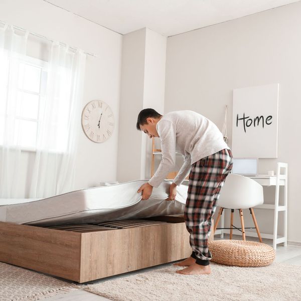 man looking at mattress