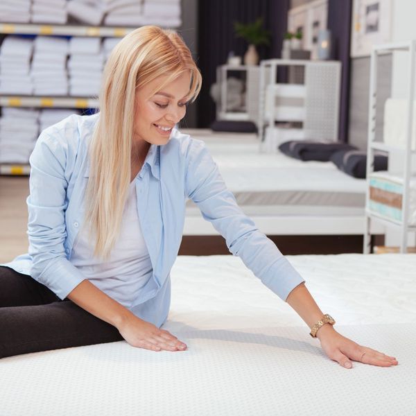 woman looking at mattress