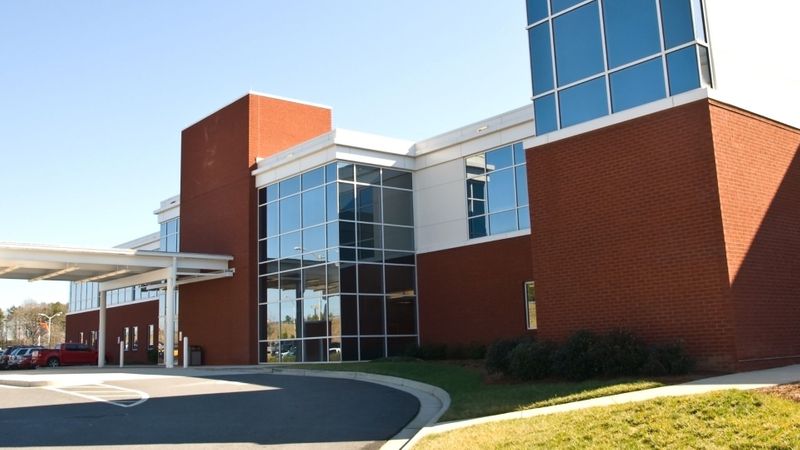 generic hospital entrance, red brick and glass walls