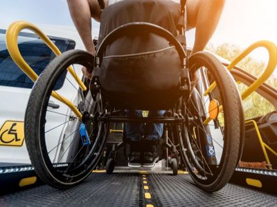 man in wheel chair getting in van