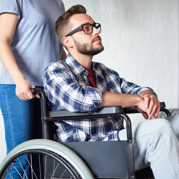 pushing man in wheel chair
