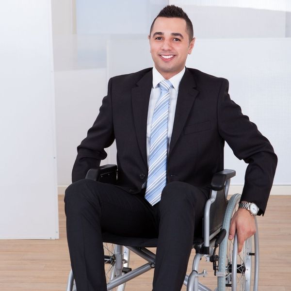 man in suit sitting in wheelchair