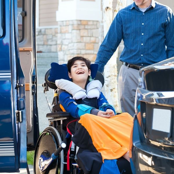wheelchair user being loaded into accessible van