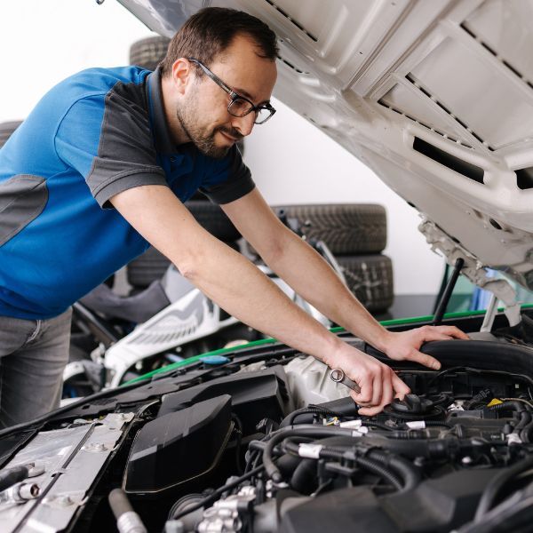 auto tech working under hood