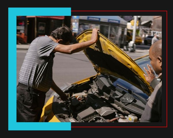 person looking into car engine