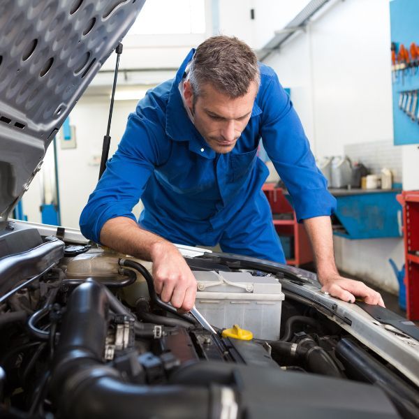 auto tech working under hood