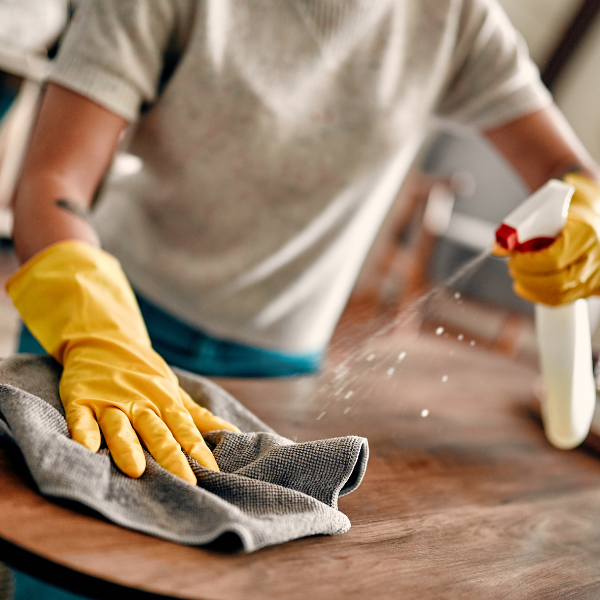 Person cleaning a table. 
