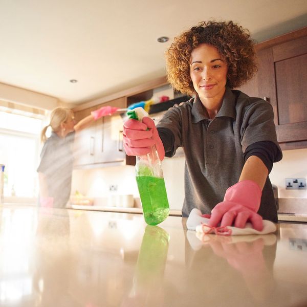 professional team cleaning kitchen cabinets and counters