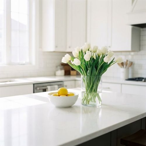 Bright kitchen counter with flowers symbolizing the seasonal nature of deep cleaning.