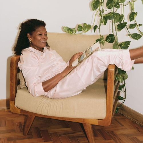 woman relaxing in chair reading magazine