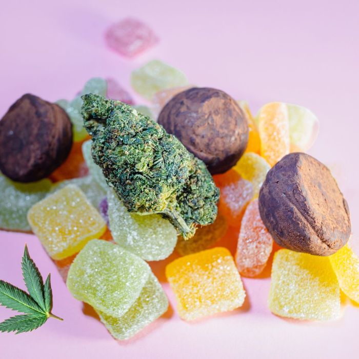 Various THC gummies with a cannabis bud on top. 