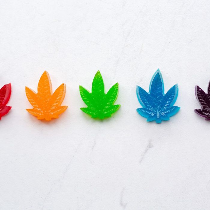 Colorful THC gummies shaped like weed leaves. 