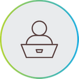 Line art icon of a person sitting behind a desk or laptop, enclosed in a blue and green circular border.