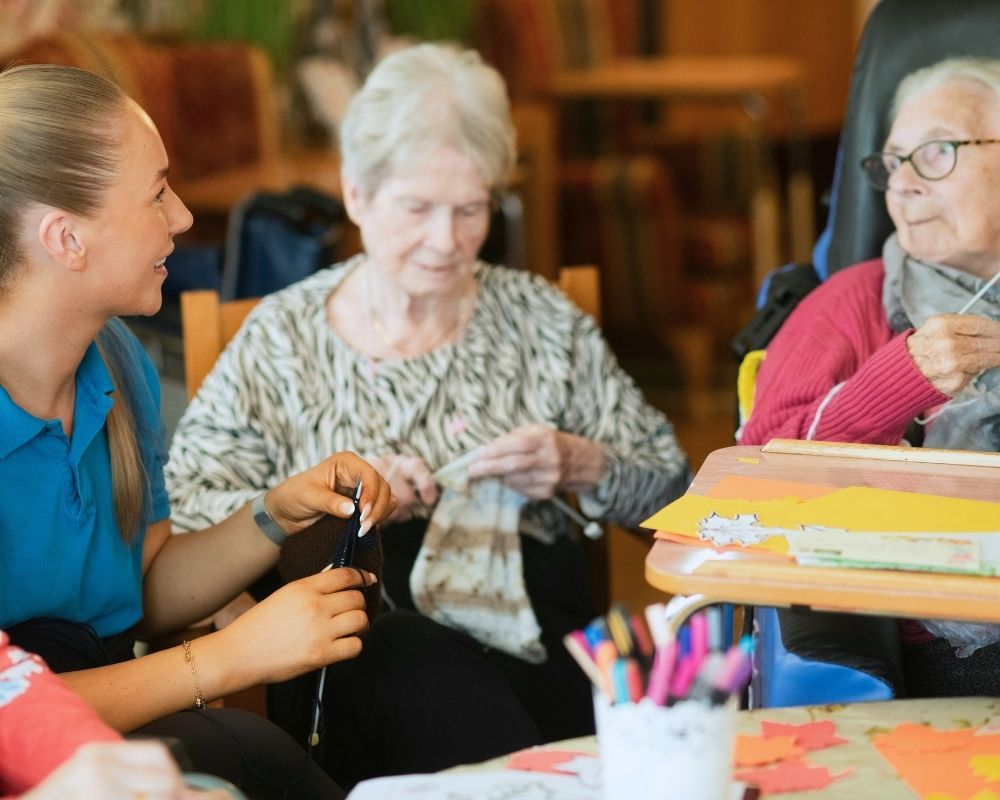 nurse knitting with elderly women