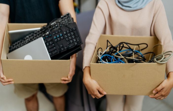 people carrying e-waste