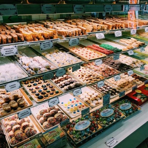 Paisano's display case filled with a variety of Italian cookies and pastries in a bakery. Paisano's display case filled with a variety of Italian cookies and pastries in a bakery.