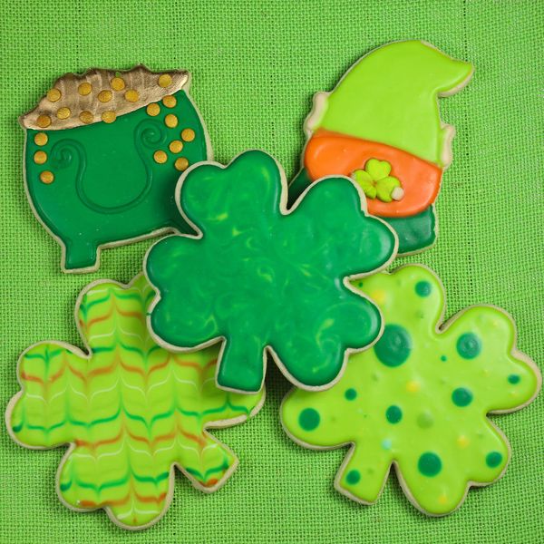 saint patricks day themed cookies arranged on a green fabric background