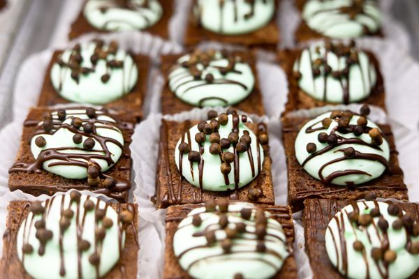 frosting covered brownies with chocolate drizzle