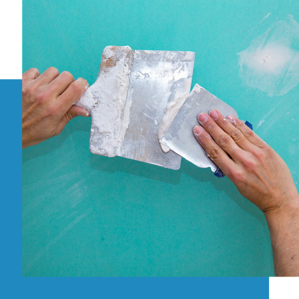 applying spackle to wall