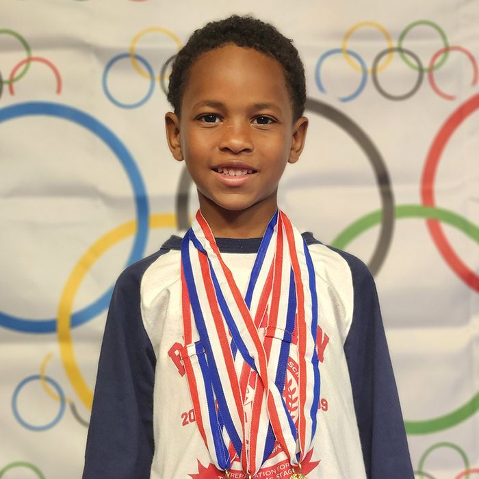 child with olympic medals