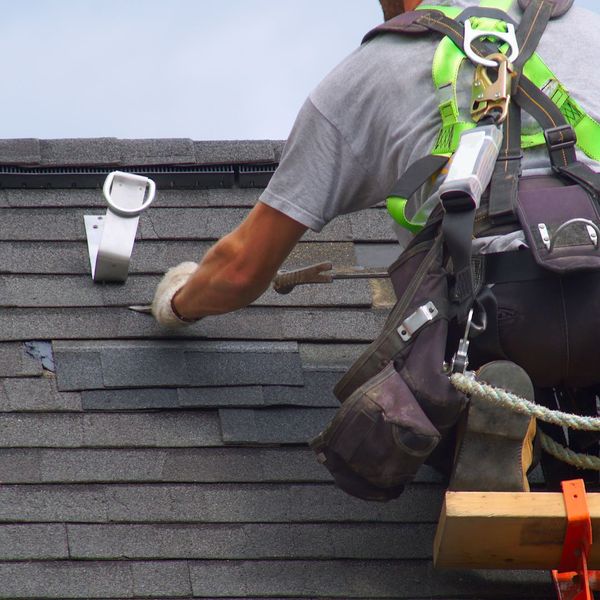 roofer repairing shingles