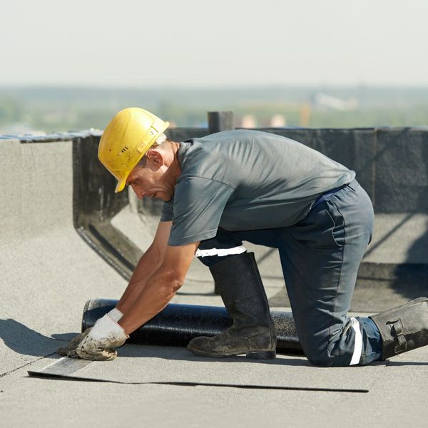 roofer working on commercial roof